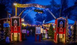 Picture off the Christkindl Entrance at dusk with pretty lights.