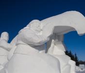 Ice sculpture of voyageurs carrying a canoe at Festival du Voyageur