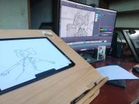 Picture of tablet with graphic art drawing and computer screen with digital art drawing at the Screen Arts Institute.