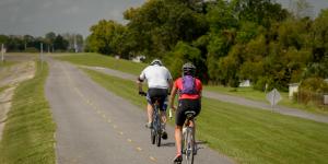 Two men riding bikes on the Levee Bike Path in Kenner, LA