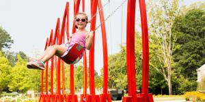 Red swings at the Abernathy Greenway Playable Art Park