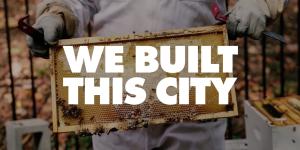 We Built This City logo (Mayor Rusty Paul holding a screened board from the hive with honey on it