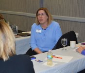 A group of women chat around a table at the March 2018 Industry Insider Training