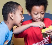 Two Black children play with building toys at the Children's Museum