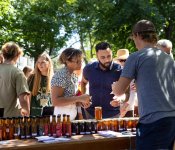 Two people sample salsa at the Dane County Farmers' Market
