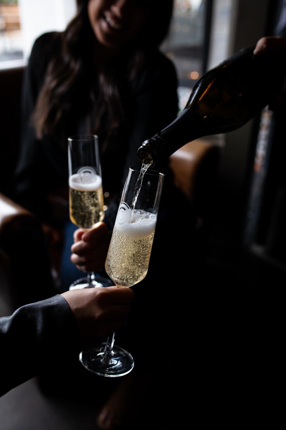 This is an image of two glasses of sparkling wine from Caraccioli Cellars in Carmel-by-the-Sea