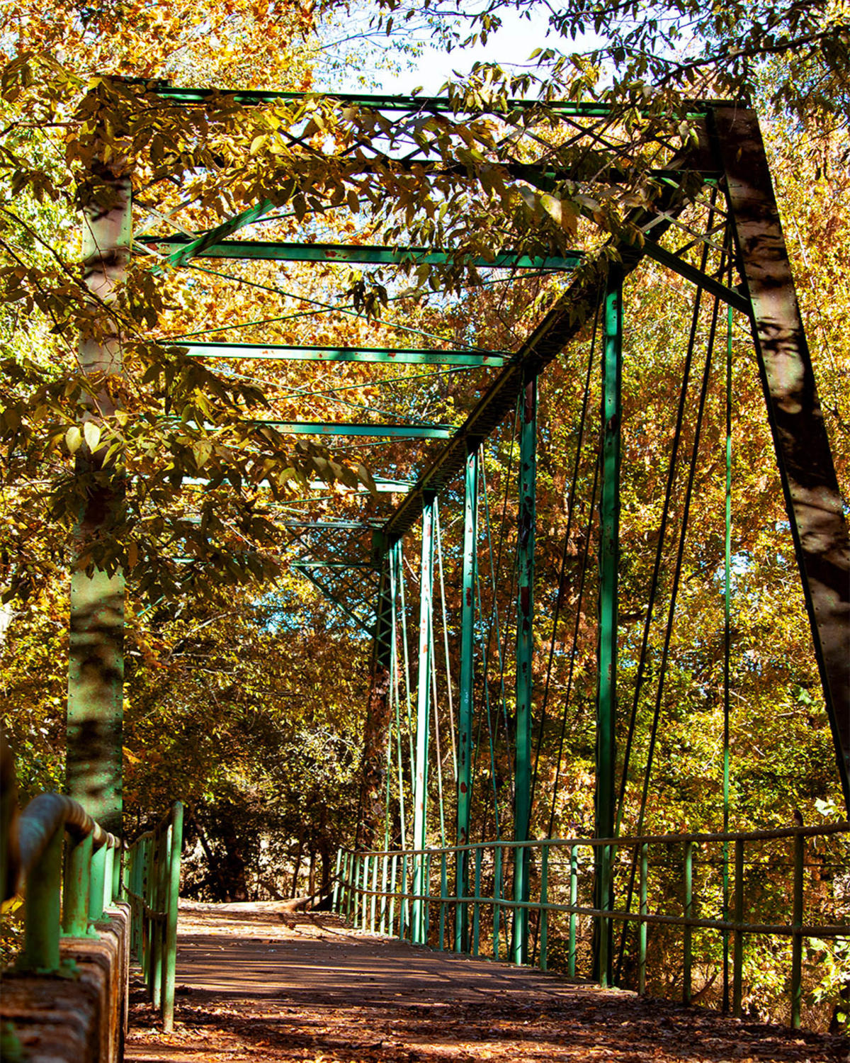 a historic bridge surrounded by fall foliage