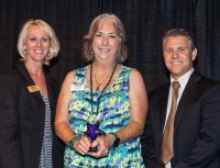 Attraction Hero Valerie Wolfrey accepts her award from FRLA's Lois Croft and the VCB's Sean Doherty