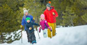 A family enjoys snowshoeing in the winter in Steamboat Springs, Colorado