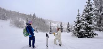 Guide and woman talking on historic snowshoe tour in Park City