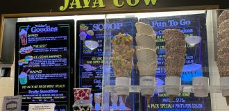 Waffle cones in front of Java Cow sign and menu