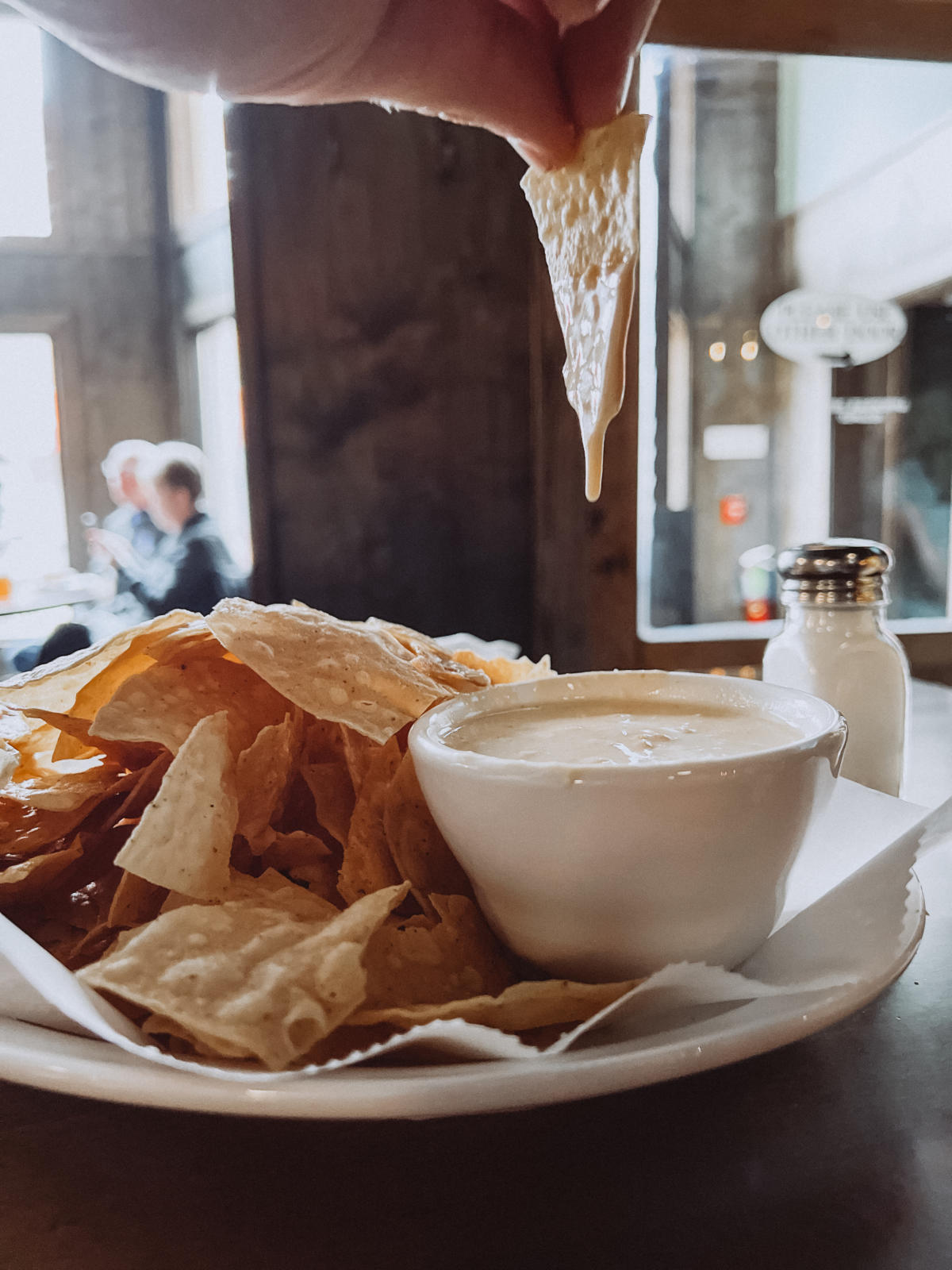 beer cheese dip dripping from chip