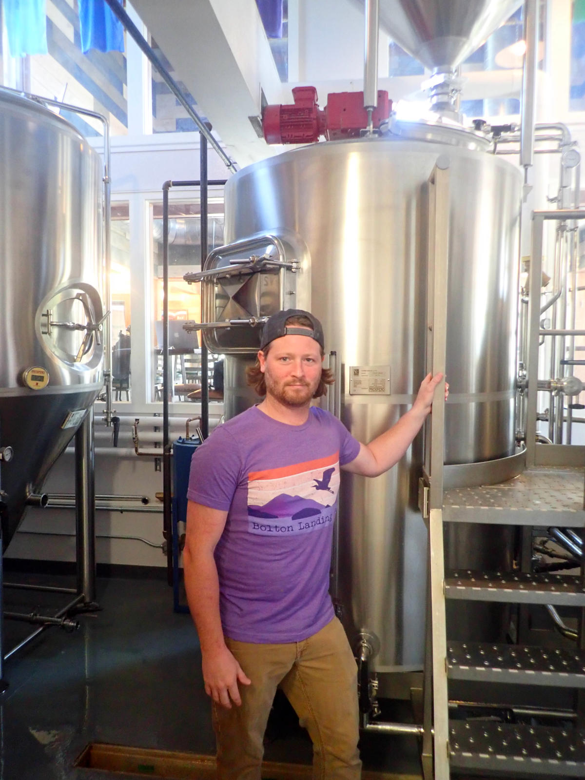 Shawn Kerr at the Bolton Landing Brewing Company in front of a kettle