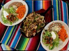 Picture of plates of delicious Mexican food and a skillet with fajitas at El Torito