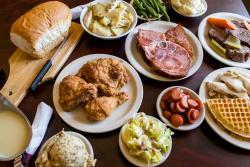 Yummy Food From Masser's on lots of plates displayed on a dining table at their restaurant.