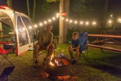 Father and Son sitting by the fire at Knoebels Campground