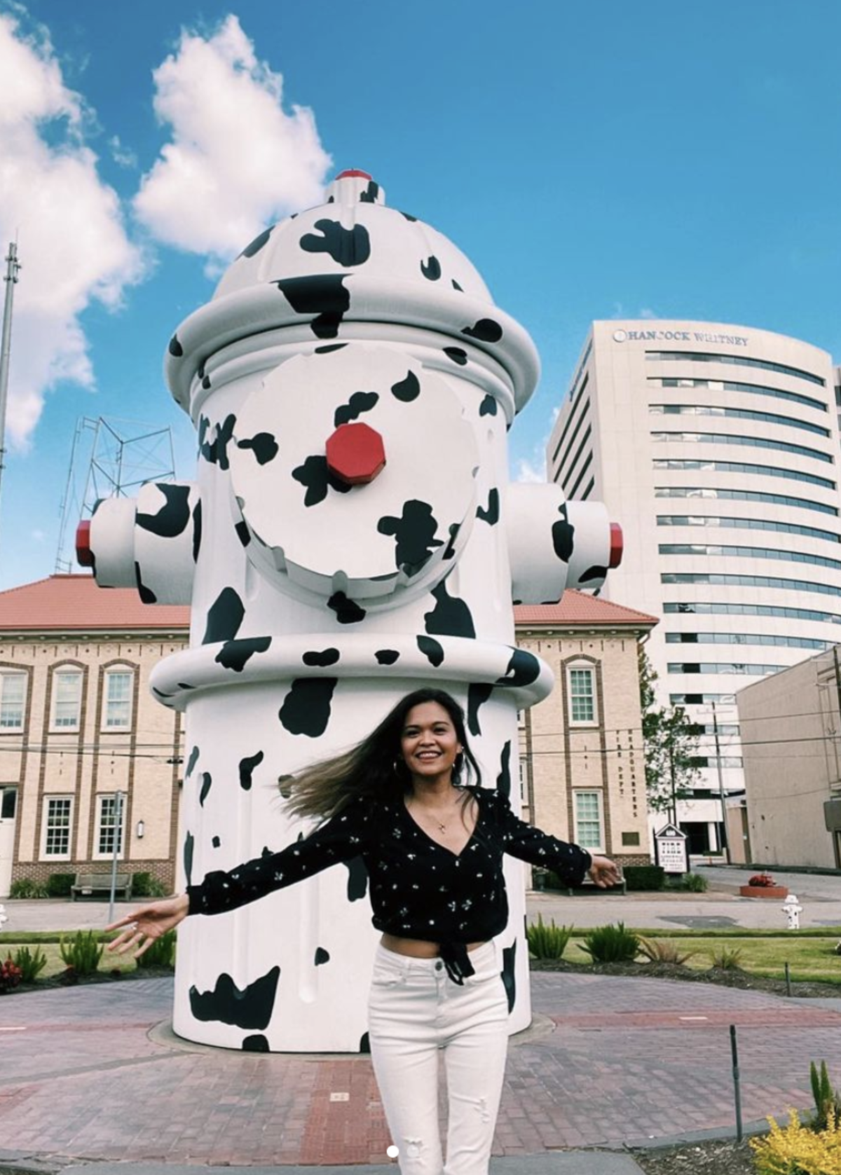 A visitor poses in front of the Dalmatian-inspired fire hydrant at the Fire Museum of Texas.