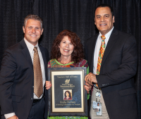 2022 Tourism Hall of Fame Winner Kathy Burnam, accepting her award from Tourism Director Sean Doherty and County Commissioner Christopher Constance