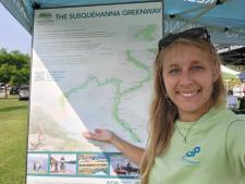 Picture of the Susquehanna Greenway Partnership Map and Alana with SGP pointing to the map.
