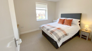 A bedroom at one of the self-catering apartments at Sunstone, Staffordshire
