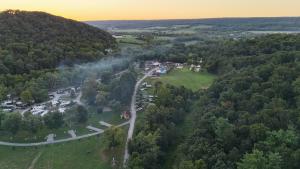Picture of Little Mexico Campground from an arial perspective. Sunset in the background with view of the tree covered hillsides flowing to the campground.