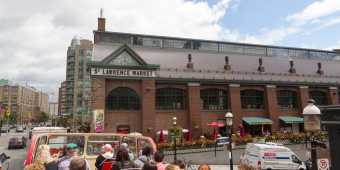 A view of the exterior of St Lawrence Market from a tour bus in summer