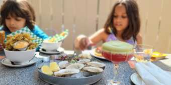 Children eating at a table at Mira Mira restaurant in Toronto