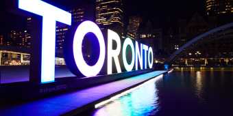 The Toronto Sign at Nathan Phillips Square lit in the evening