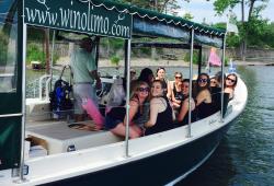 Four people riding in a boat on way to wine tour