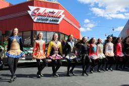 A line of Irish step dancers outside a bowling alley at Patriot Place
