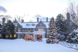 Snow-covered ground at the Blithewold estate during Christmas time