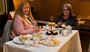 A mother and daughter enjoy afternoon tea at Statfold Country Park, with plenty of cakes, sandwiches and pots of tea