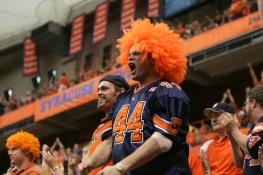 Man in Big Orange Wig and SU Jersey Yells to Support His Team