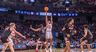 College basketball players play during an NCAA Men's Basketball Tournament Game.