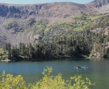 two kayaks on a lake with mountains and fall colors