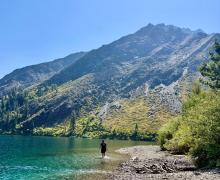Person walking in the clear water of Convict Lake