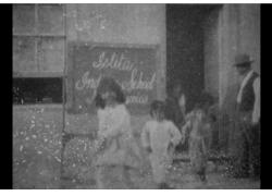 Less than a minute long, the first film shot in the territory shows children entering and exiting Isleta Indian School.