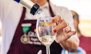 Volunteer pouring wine for GrapeFest People's Choice