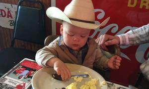 Little cowboy eating at Bill Smith's Cafe