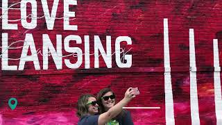 People taking a selfie in front of the Love  Lansing Street Art
