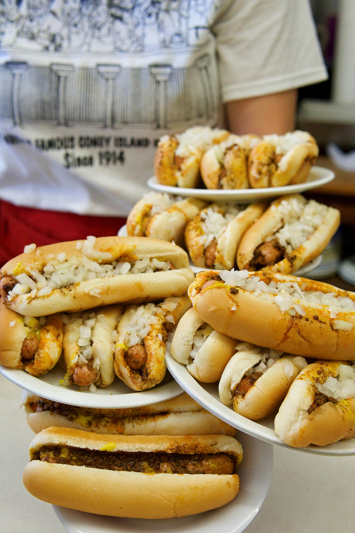 Plates of coneys stacked high at Coney Island