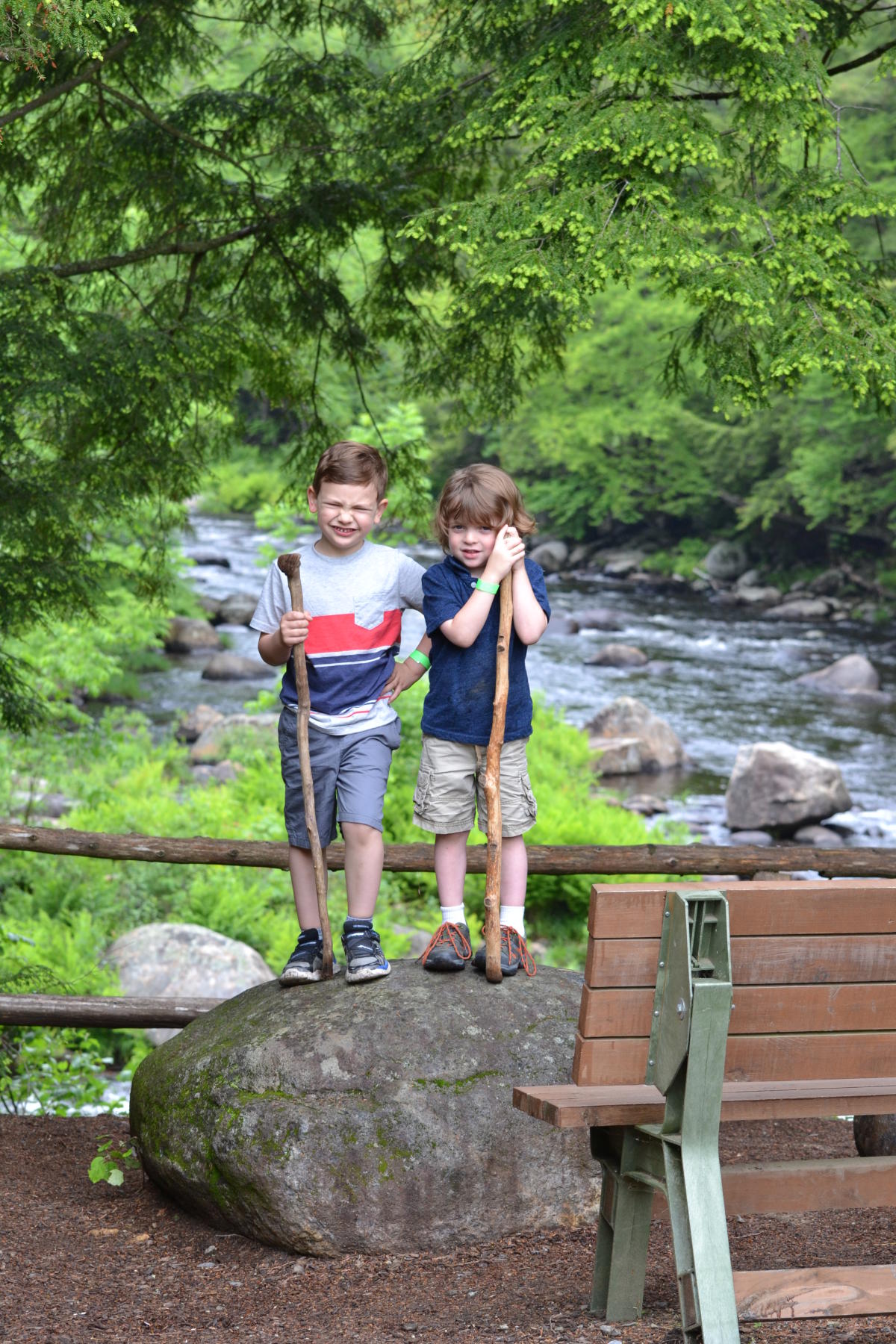 Kids standing on a rock exploring Natural Stone Bridge & Caves
