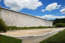 The light grey stone of the Kensico Dam and the surrounding lawn.
