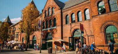 Exterior shot of Central Market House in autumn with people walking along the sidewalk