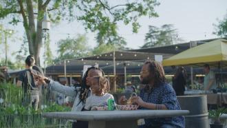 Family enjoying meal at a table at Gazebo Gardens.