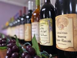 Picture of bottles of wine lined up on a shelf from Catino Vino Winery.