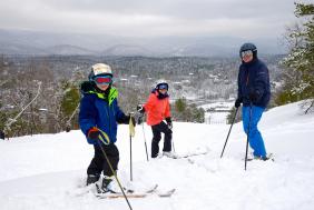 Family at top of mountain snowy view