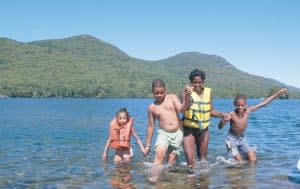 Family playing in lake george