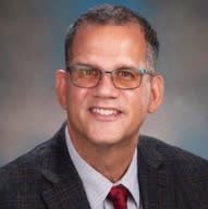 Portrait photo of Michael Scaglione wearing suit and tie.