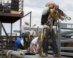 Cowboys prepare their equipment at the Hell on Wheels Rodeo